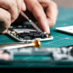 depositphotos_242963362-stock-photo-electronics-repair-service-technician-disassembling